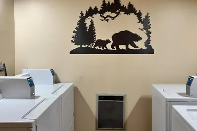 a bathroom with a bear and cub stencil on the wall at Sunrise 8 in Mammoth Lakes
