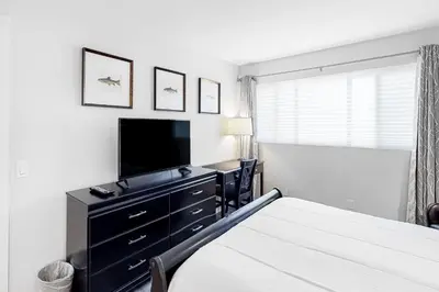a bedroom with a bed and a dresser with a television at La Residence N3 in Mammoth Lakes