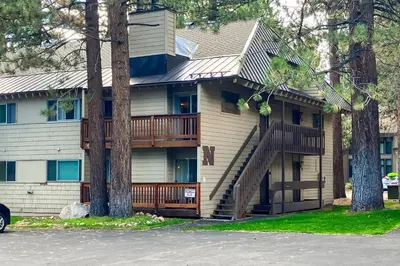 a house with a deck and stairs in front at La Residence N3 in Mammoth Lakes