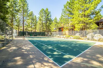 a tennis court with a tennis racket on it at La Residence N3 in Mammoth Lakes