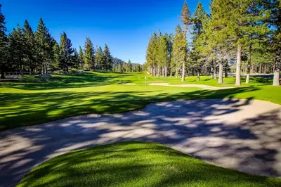 a golf course with trees and a green at La Residence N3 in Mammoth Lakes