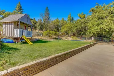 a small house with a playground in a yard at Wildcat Family Ranch in Murphys