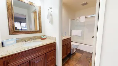 a bathroom with a sink and a toilet and a mirror at San Sierra #26 condo in Mammoth Lakes