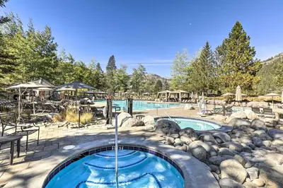 a swimming pool with a water fountain in a yard at 6 Mi to Lake Tahoe Everline Resort Retreat! in Olympic Valley
