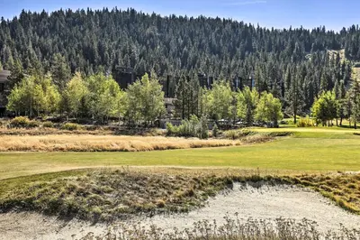 a view of a golf course with trees in the background at 6 Mi to Lake Tahoe Everline Resort Retreat! in Olympic Valley