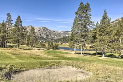 a golf course with a pond in the grass and trees at 6 Mi to Lake Tahoe Everline Resort Retreat! in Olympic Valley