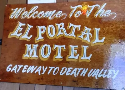 a sign that reads welcome to the el portal motel at El Portal Motel in Beatty