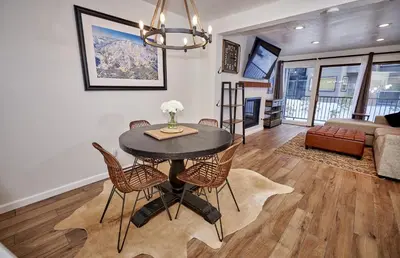 a dining room and living room with a table and chairs at St Anton Wooded View 1-Bedroom Condos with Complimentary Hot Drinks in Mammoth Lakes