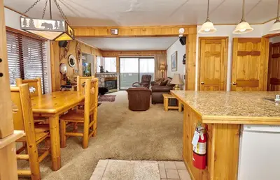 a kitchen and living room with a table and chairs at St Anton Wooded View 1-Bedroom Condos with Complimentary Hot Drinks in Mammoth Lakes