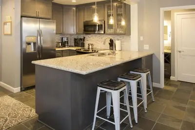 a kitchen with a large island with bar stools at St Anton Street View Ski-In & Out 1-Bedroom Condo in Mammoth Lakes