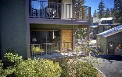 a house with a balcony with a chair on it at St Anton Street View Ski-In & Out 1-Bedroom Condo in Mammoth Lakes