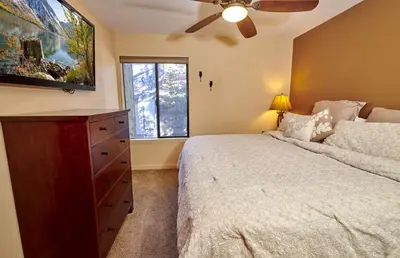 a bedroom with a bed and a ceiling fan at St Anton Courtyard View Ski-In and Out 1 Bedroom Condo in Mammoth Lakes
