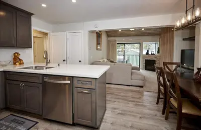 a kitchen and living room with a sink and a couch at St Anton Courtyard View 2-Bedroom Condos with two oversized jacuzzi spas in Mammoth Lakes