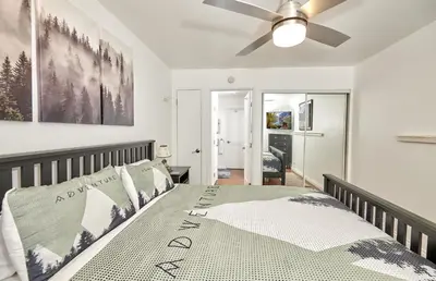 a bedroom with a bed with a ceiling fan at St Anton Condos with Rec Center in Mammoth Lakes