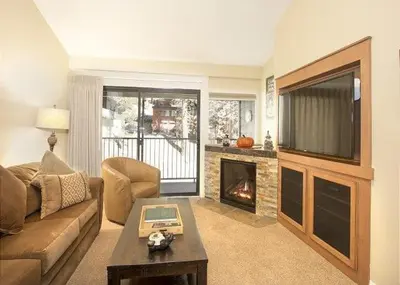 a living room with a couch and a fireplace at St Anton Street View 2-Bedroom Condo with full kitchen in Mammoth Lakes