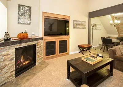 a living room with a fireplace and a television at St Anton Street View 2-Bedroom Condo with full kitchen in Mammoth Lakes