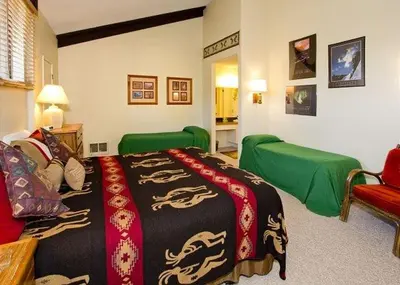 a bedroom with a bed with a blanket on it at St Anton Courtyard View 2-Bedroom Condo with full kitchen in Mammoth Lakes