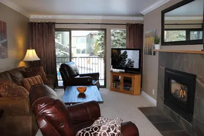 a living room with leather furniture and a fireplace at St Anton Courtyard View 1-Bedroom Condos with Dry Sauna in Mammoth Lakes