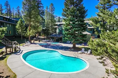 a swimming pool in the yard of a house at St Anton Courtyard View 2-Bedroom Condos with Pool & Jacuzzi in Mammoth Lakes
