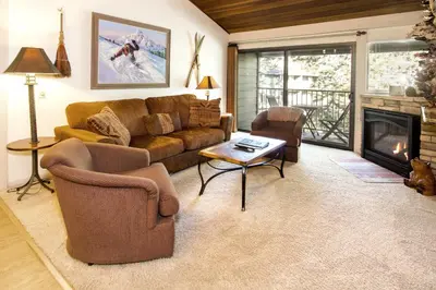 a living room with a couch and a fireplace at St Anton Courtyard View 2-Bedroom Condos with Pool & Jacuzzi in Mammoth Lakes