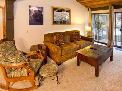 a living room with a couch and a coffee table at St Anton Courtyard View 2-Bedroom Condos with Pool & Jacuzzi in Mammoth Lakes