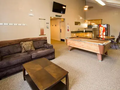 a living room with a couch and a pool table at St Anton Wooded View 2-Bedroom Condos with Ski Lockers in Mammoth Lakes