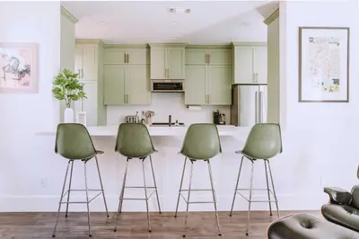 a kitchen with three green stools in front of a counter at Sacramento Guest House with Patio about 5 Mi to Downtown in Sacramento