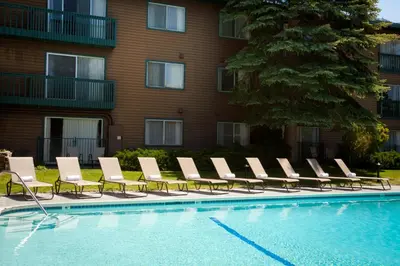 a row of lounge chairs next to a swimming pool at Forest Suites Resort at the Heavenly Village in South Lake Tahoe