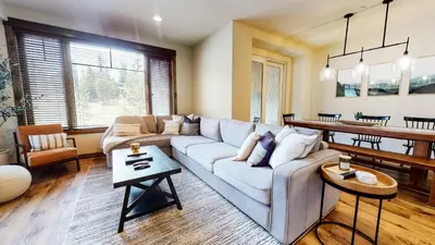 a living room with a couch and a table at Woodwinds #1265 townhouse in Mammoth Lakes