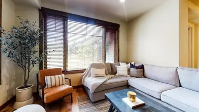 a living room with a couch and a table at Woodwinds #1265 townhouse in Mammoth Lakes