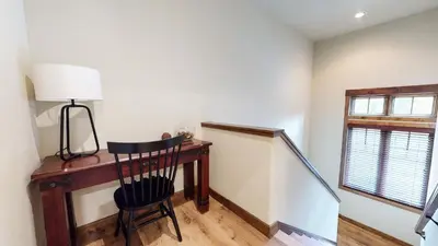 a room with a desk with a lamp and a chair at Woodwinds #1265 townhouse in Mammoth Lakes
