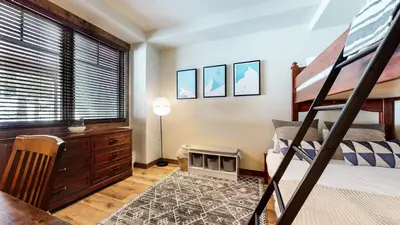 a bedroom with a bunk bed and a desk at Woodwinds #1265 townhouse in Mammoth Lakes
