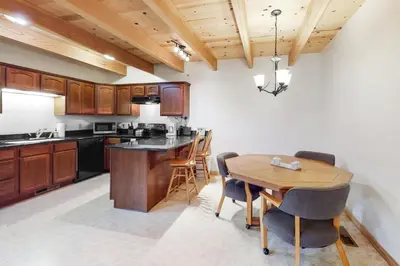 a kitchen with a wooden table and a dining room at Inntopia in Zephyr Cove
