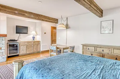a bedroom with a bed and a table and a tv at Our Lake House in Zephyr Cove