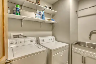 a laundry room with a washer and dryer and a sink at Our Lake House in Zephyr Cove