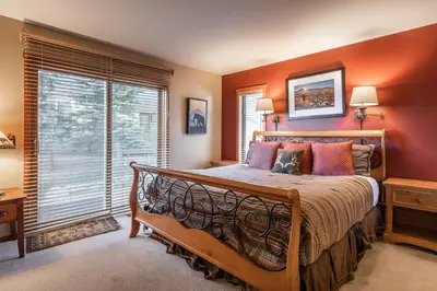 a bedroom with a large bed and a window at Snowcreek V 963 in Mammoth Lakes
