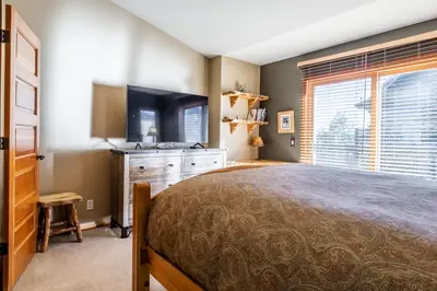 a bedroom with a large bed and a television at Snowcreek V 963 in Mammoth Lakes