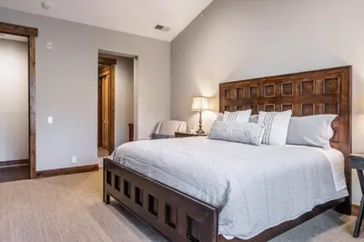 a bedroom with a large bed with a wooden headboard at Lodges 1138 in Mammoth Lakes