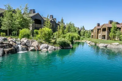 a river with rocks in front of a house at Lodges 1138 in Mammoth Lakes