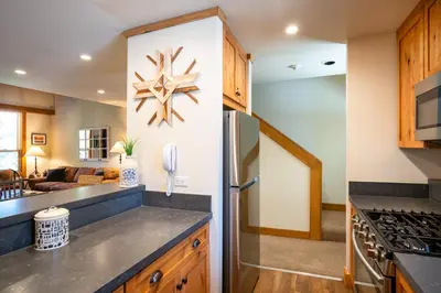 a kitchen with a refrigerator and a living room at Northstar - Gold Bend Getaway in Truckee