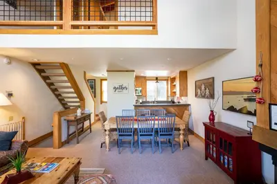 a dining room and living room with a table and chairs at Northstar - Gold Bend Getaway in Truckee