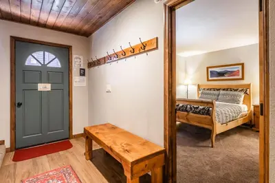 a room with a door and a bed and a mirror at Helios 9N in Mammoth Lakes