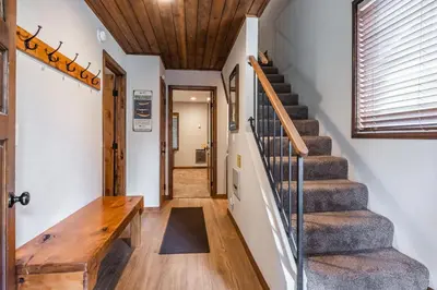 a hallway with stairs and a wooden table at Helios 9N in Mammoth Lakes