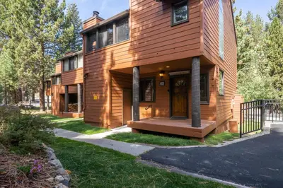a wooden house with a porch and a fence at Helios 9N in Mammoth Lakes