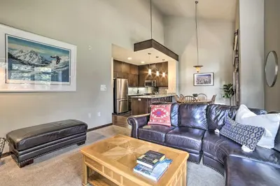 a living room with a leather couch and a table at Modern Mammoth Lakes Condo Ski, Hike, and More! in Mammoth Lakes