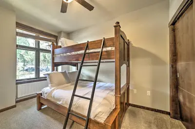 a bunk bed in a room with a ladder at Modern Mammoth Lakes Condo Ski, Hike, and More! in Mammoth Lakes