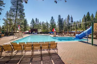 a swimming pool with chairs and a slide at Grey Fireplace in Truckee