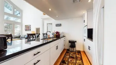 a kitchen with white cabinets and a black counter top at Snowcreek #840 condo in Mammoth Lakes