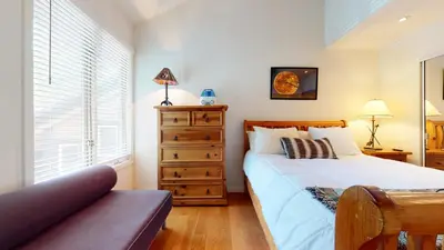 a bedroom with a bed and a dresser and a window at Snowcreek #840 condo in Mammoth Lakes
