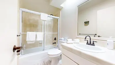 a white bathroom with a toilet and a sink at Snowcreek #840 condo in Mammoth Lakes